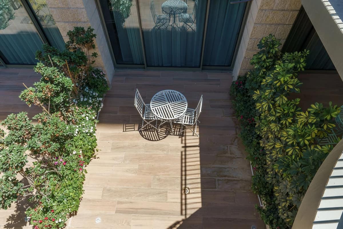 Private garden courtyard with Jerusalem-stone paving at Haneviim Boutique, central Jerusalem