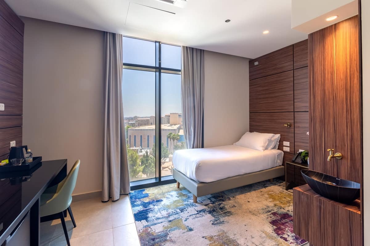 Guest room with work desk and city view at Hotel Yirmiyahu 33, Romema, Jerusalem