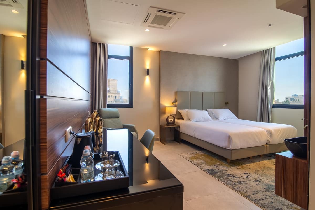 King suite with walnut paneling at Hotel Yirmiyahu 33 — Mehadrin kosher hotel in Romema, Jerusalem